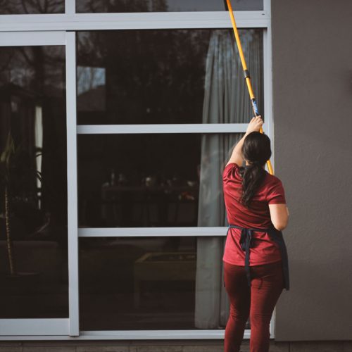 Girl Cleaning Outside Window